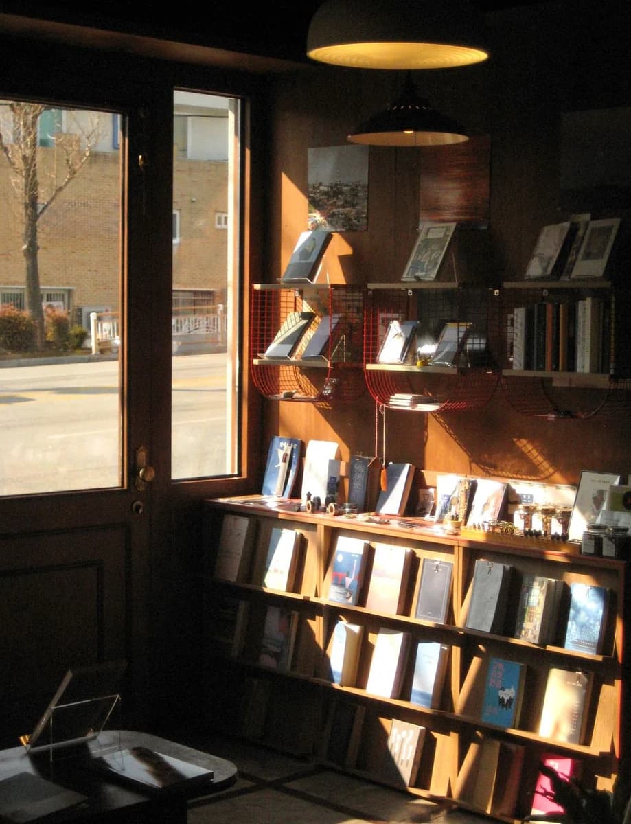 The interior of a secondhand bookshop at dusk