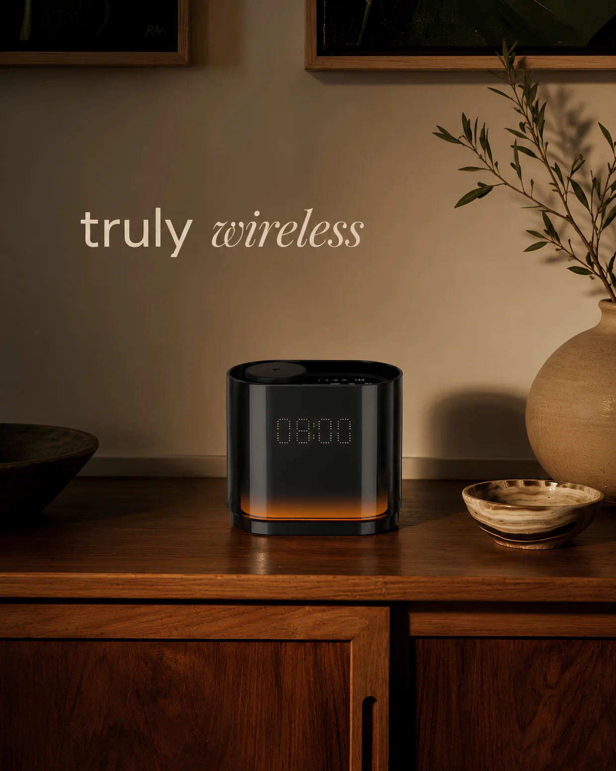 The Quint clock diffuser glowing 08:00 on a wooden sideboard — truly wireless