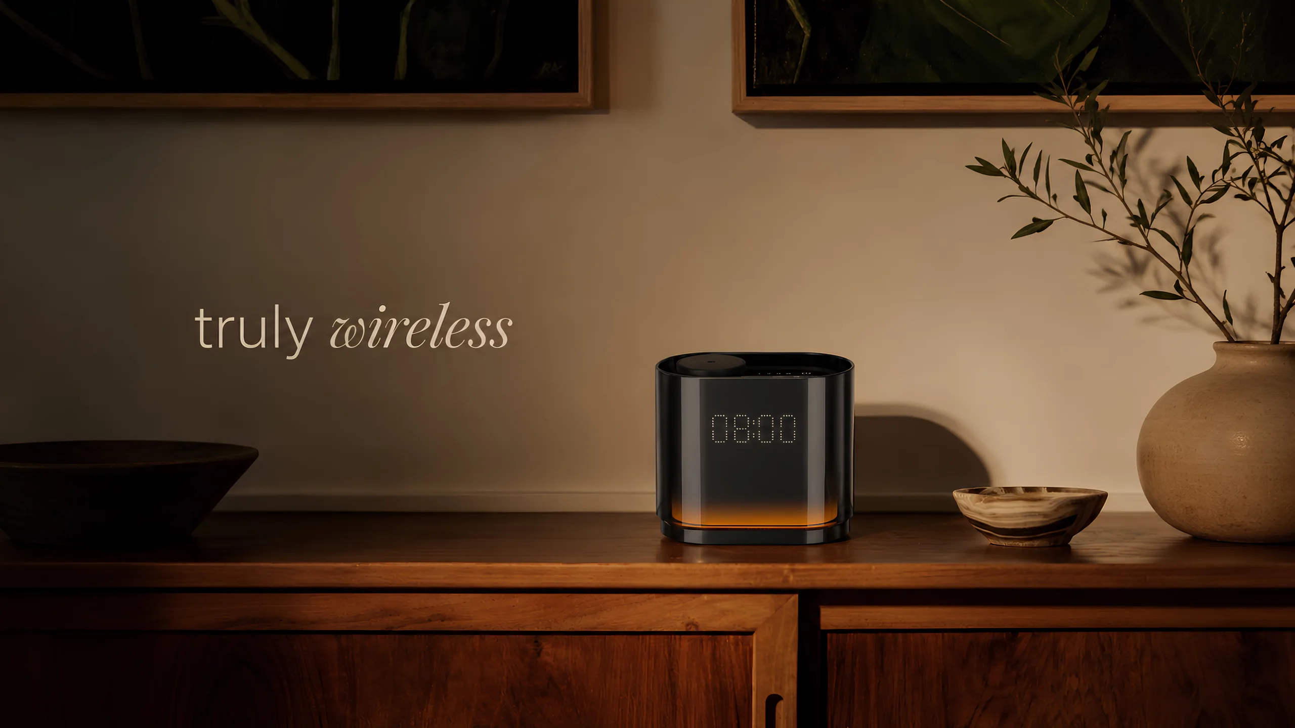 The Quint clock diffuser glowing 08:00 on a wooden sideboard — truly wireless